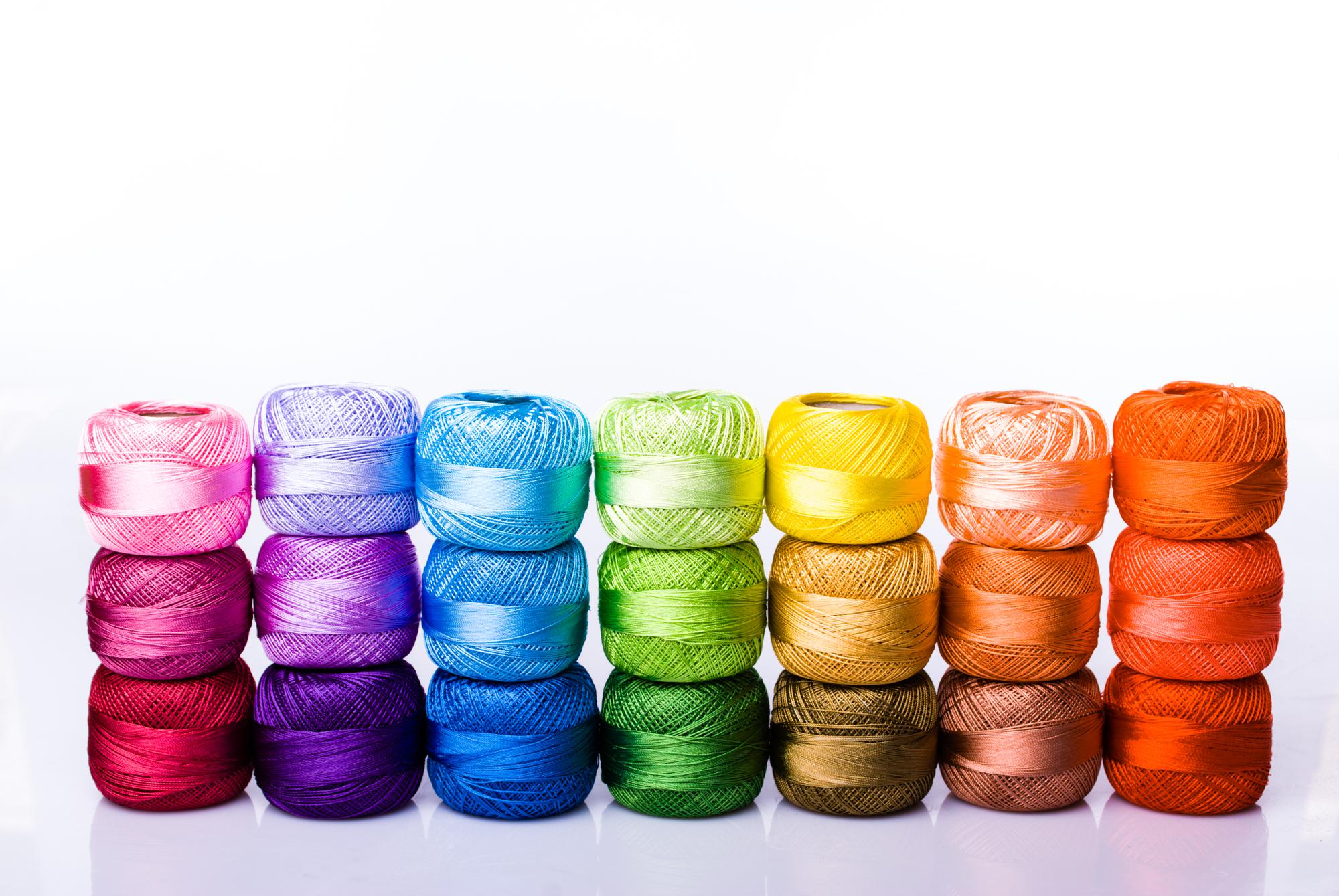 Thread spools in bold colors arranged on table